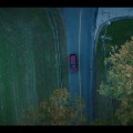 Drone shot – the camera tilts down 90 degrees as the car&nbsp;passes…
