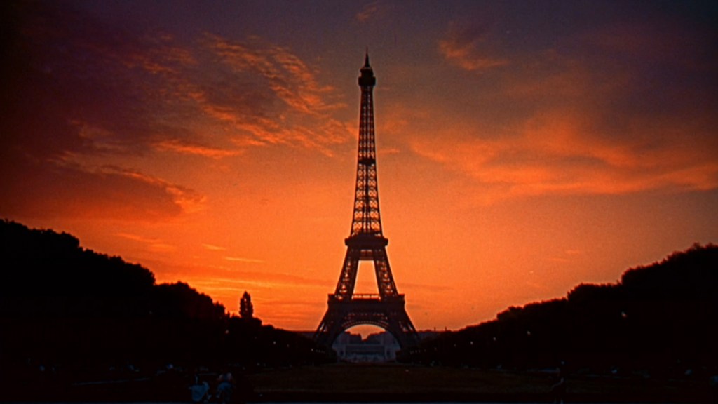 Silhouette of the Eiffel Tower against a vibrant sunset sky.