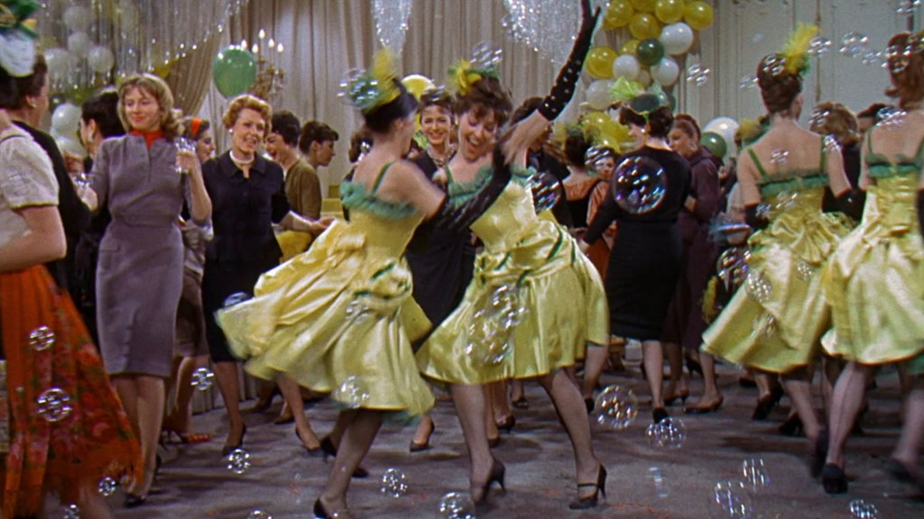 A lively dance scene at a party featuring women in yellow dresses, dancing among bubbles and colorful balloons.