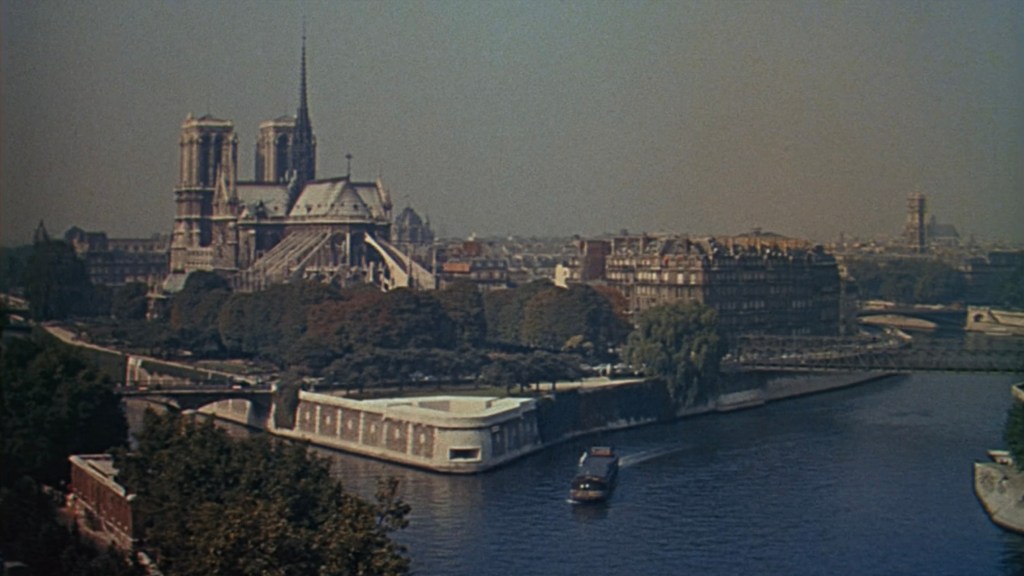 A scenic view of the Seine River with a boat sailing, surrounded by lush greenery, featuring the iconic Notre-Dame Cathedral and historic buildings in the background.