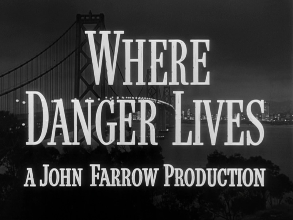 Title screen for the film 'Where Danger Lives,' directed by John Farrow, featuring a silhouette of a bridge and a city skyline against a dark background.