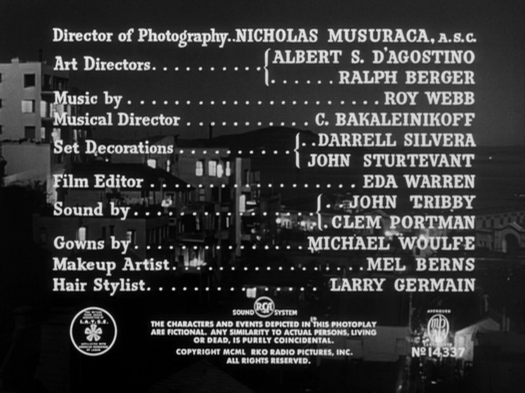 Credits screen displaying various film crew roles including Director of Photography, Art Directors, Music by, Film Editor, and others, set against a cityscape background.
