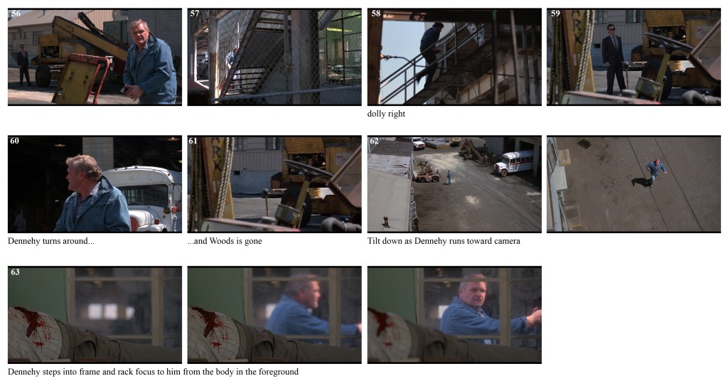 A man in a blue jacket stands in an industrial setting with machinery around him.