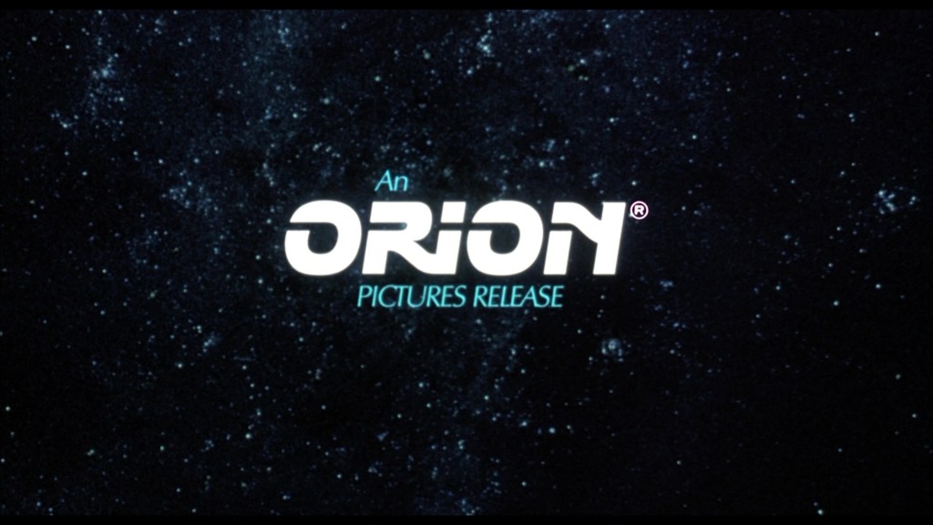 A logo for Orion Pictures set against a starry background, featuring the text 'An ORION PICTURES RELEASE'.