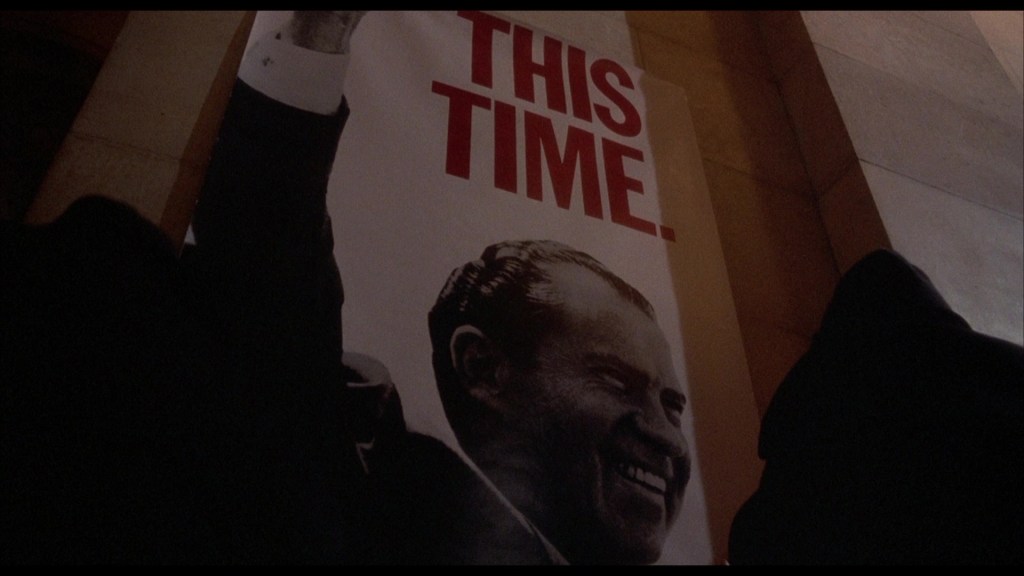 A poster featuring a smiling Richard Nixon with the text 'THIS TIME.' prominently displayed.