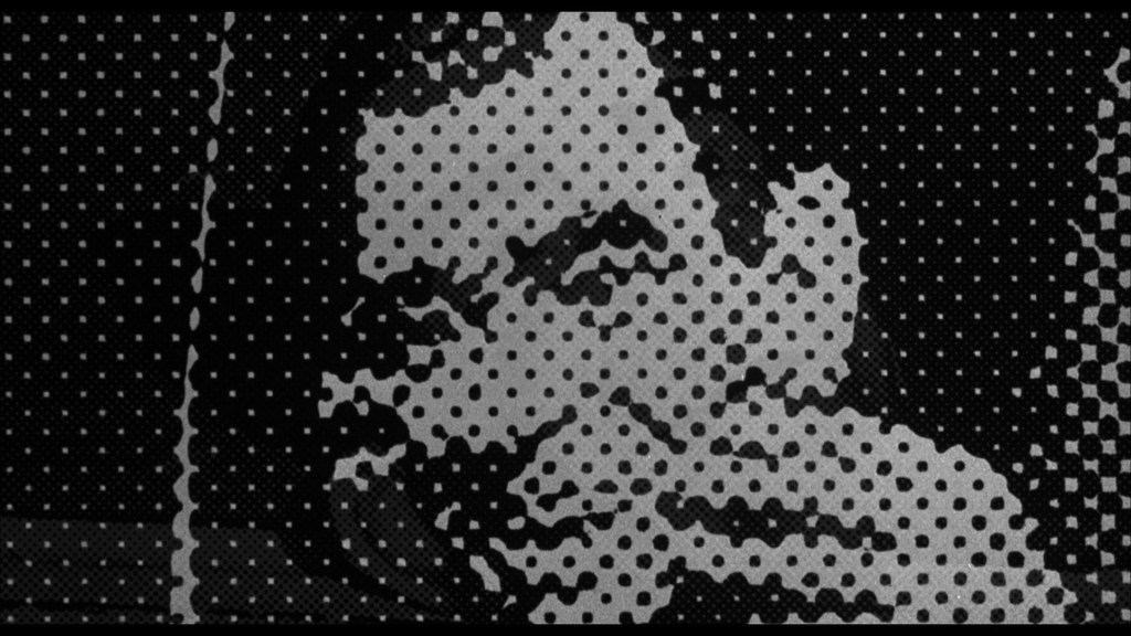 A stylized black and white dotted portrait of a smiling man, featuring a hand gesture near his face.