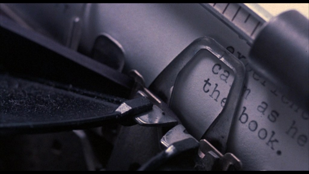 Close-up of a typewriter showing keys and partially visible typed text.