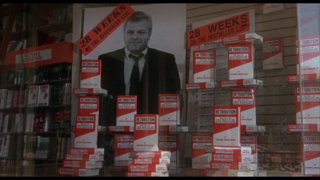 A display of books in a store featuring multiple copies of a title called 'Retribution' by Dennis Meechum, with a large promotional poster stating '28 WEEKS ON THE BESTSELLER LIST' in the background.