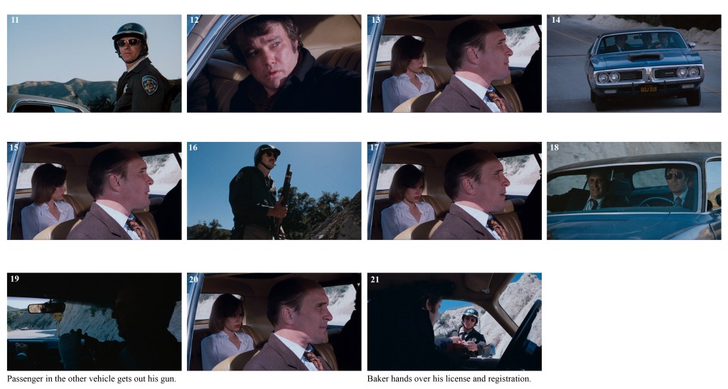 A police officer stands by a roadside looking back at a car.