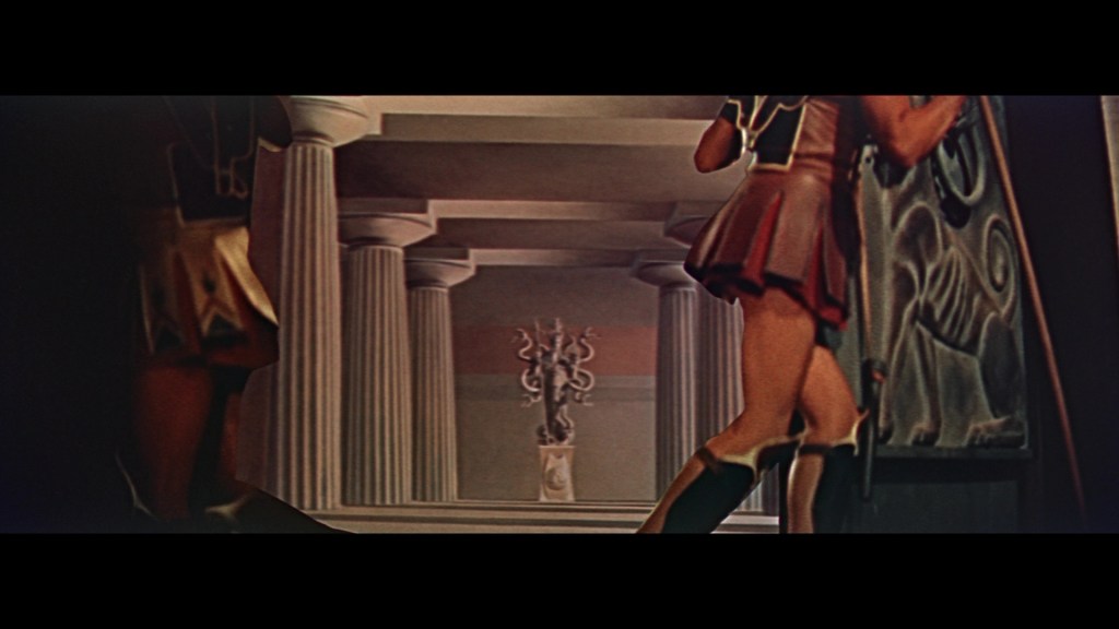 A scene depicting two figures in ancient warrior attire, walking toward a doorway in a grand architectural setting featuring columns and a decorative statue.