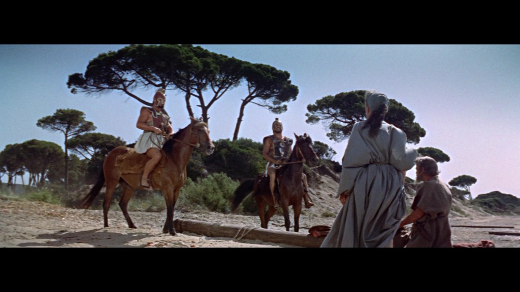Two armored horsemen on horseback face a group of three individuals on foot near a sandy area with trees in the background.