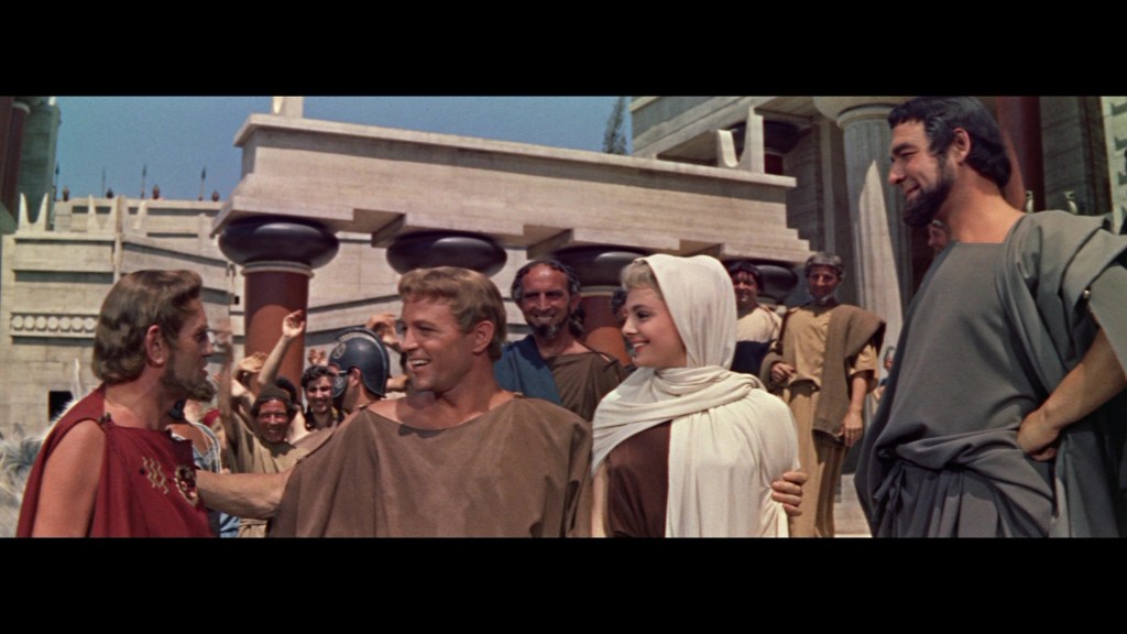 A scene depicting ancient Greek-style characters engaging in conversation, with a vibrant backdrop featuring classical architecture and a crowd of onlookers.