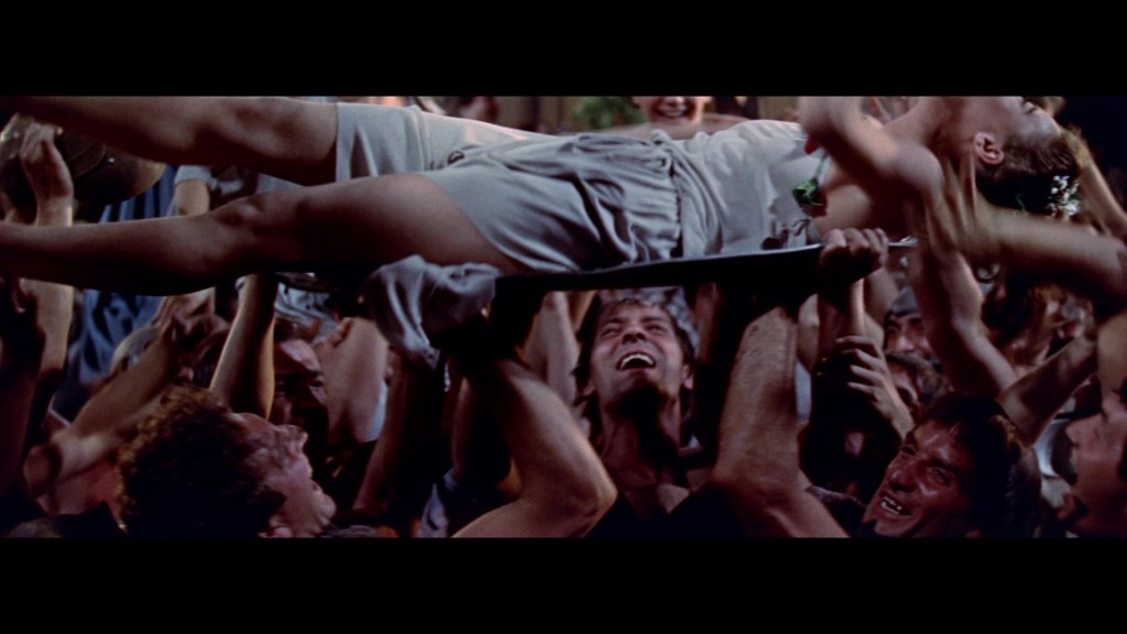 A crowd of people lifting a woman above their heads at a lively event, celebrating joyfully.