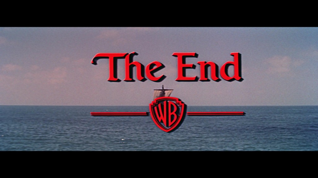A cinematic title card displaying 'The End' over a serene ocean background, with a ship silhouette and the Warner Bros logo below.