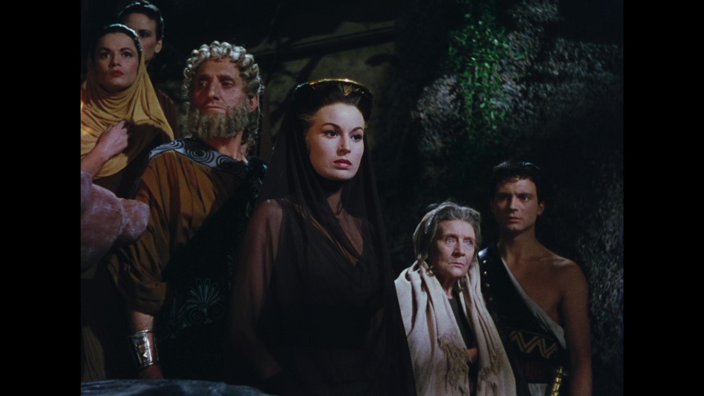 A group of six characters standing in a dramatic pose, dressed in historical or fantasy attire, with expressions of concern or intensity, set against a dark and moody background.