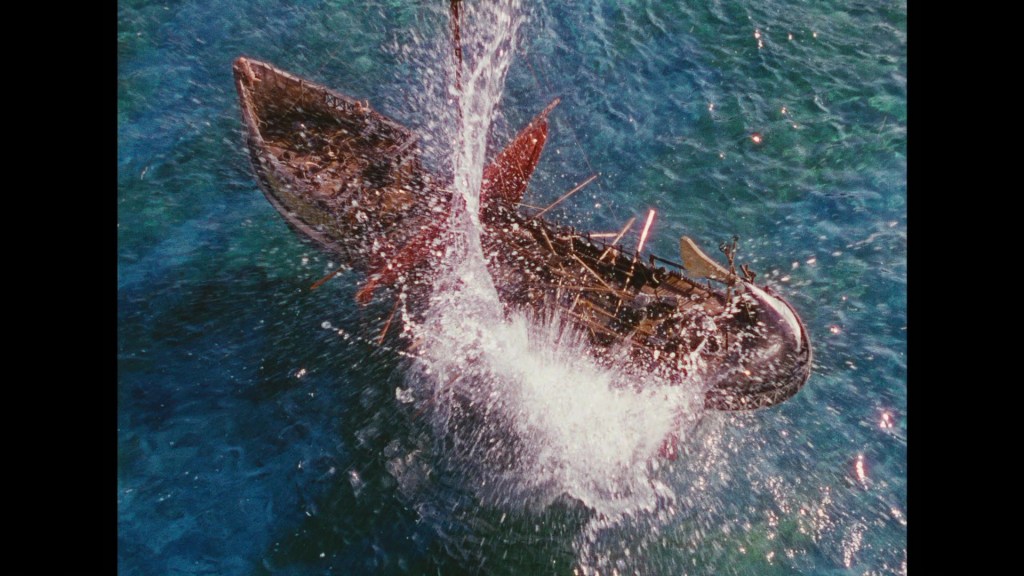 A boat partially submerged in water, creating a splash as it tips over.