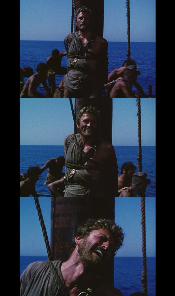 A man in ancient attire with a beard appears distressed and tied to a wooden post on a ship, against a backdrop of the ocean. Surrounding him are several other men engaged in labor, emphasizing a scene of hardship.