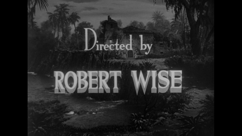 Text that reads 'Directed by ROBERT WISE' over a scenic backdrop featuring trees and a structure.