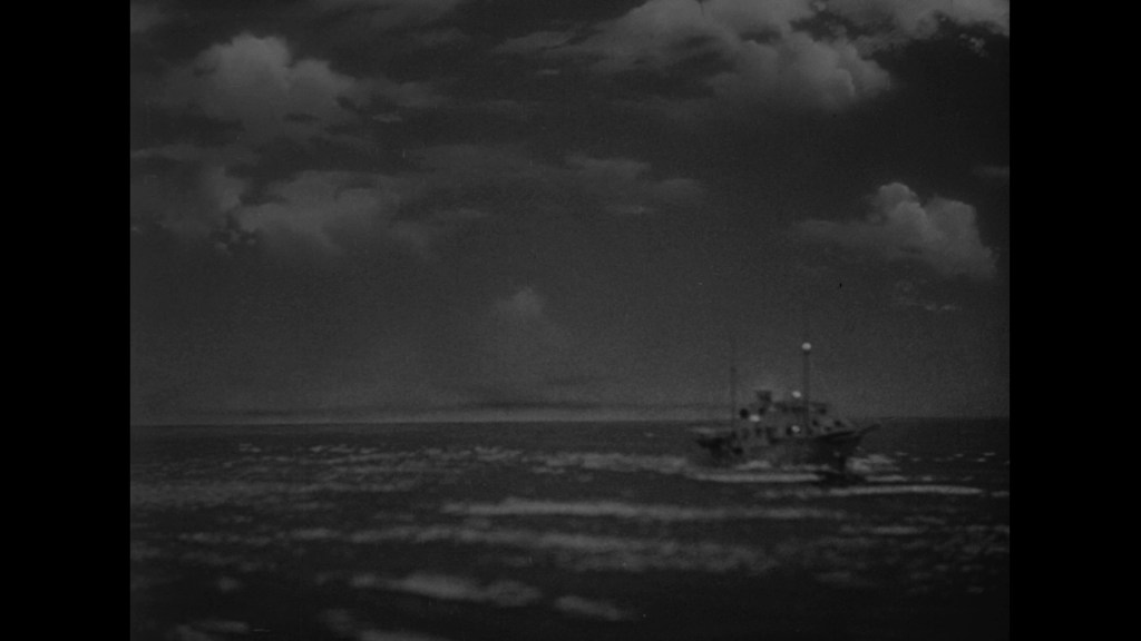 A blurred black and white image of a boat navigating through dark waters under a cloudy sky.