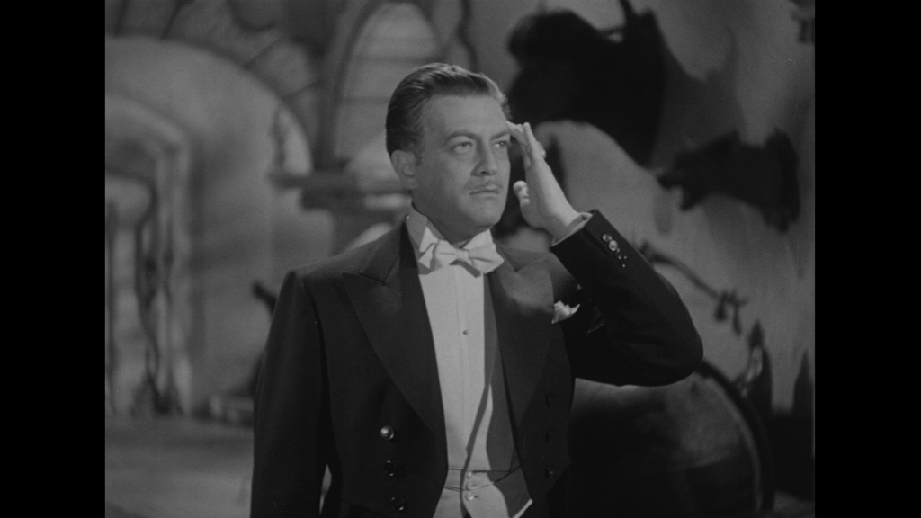 A man in a tuxedo performing a salute, set against a stylized backdrop.
