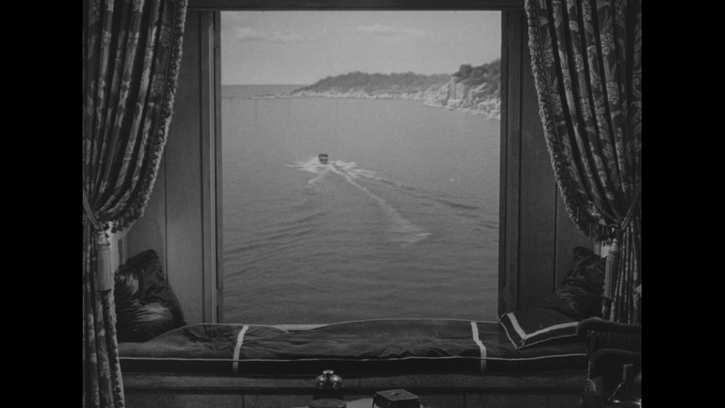 A view from a window overlooking a serene body of water, with a boat gliding across the surface. The scene is framed by luxurious curtains and features a cozy resting area with a dark blanket.