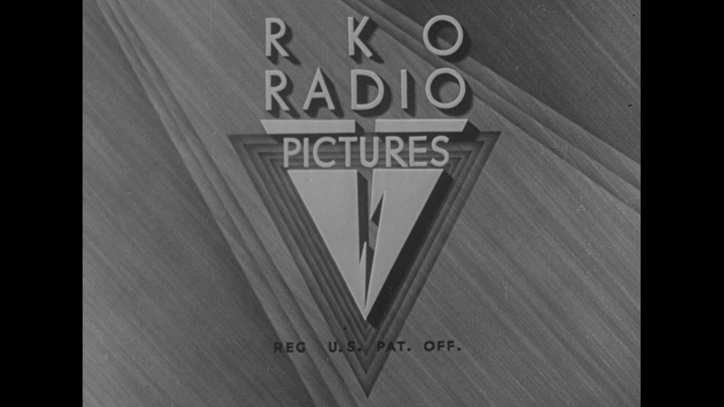 RKO Radio Pictures logo with stylized text and geometric design against a textured background.